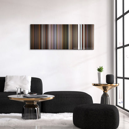 Little Nicky color palette canvas above a black sofa with a gold-topped table