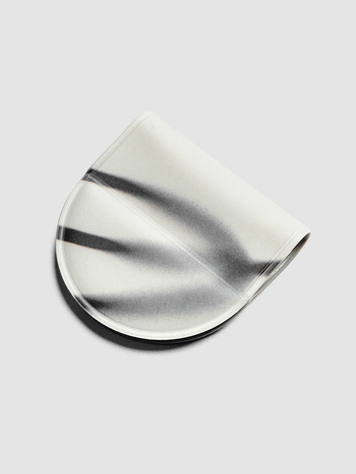 Magnetic Bookmark | Pen Holder | Vinyl in Blurred Line, angled view showing white base with sweeping dark gray brushstroke pattern
