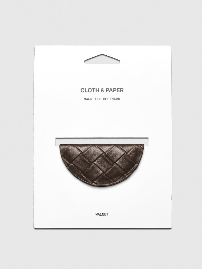 Woven vegan leather magnetic bookmark in the color walnut shown on a backing card.