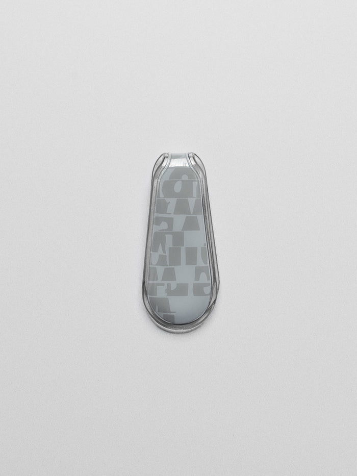 Blue patterned magnetic bookmark shown closed, laying flat on a neutral background.