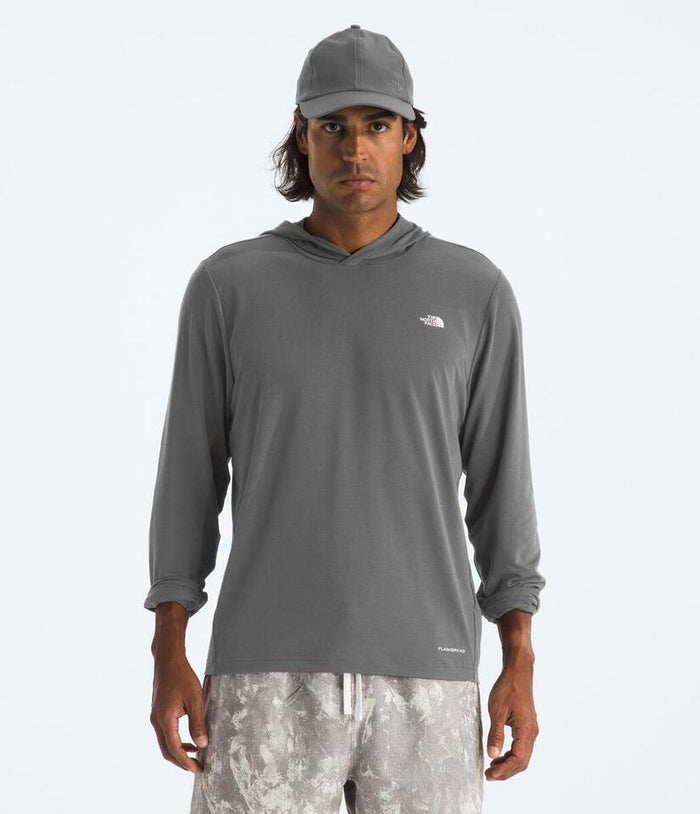 Man wearing a gray hoodie with a logo on a white background
