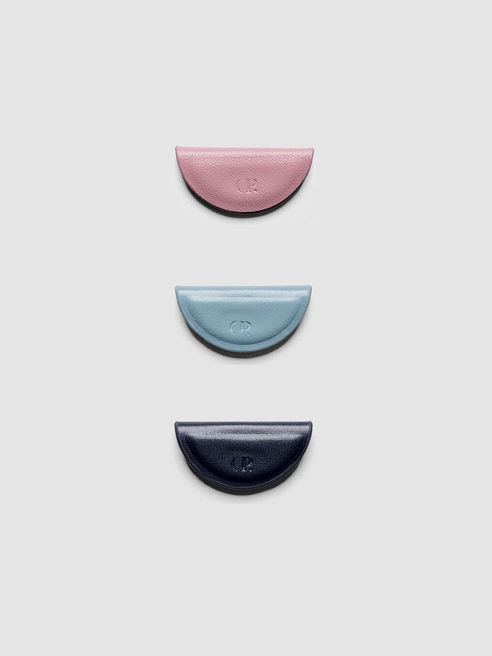 Set of three mini magnetic bookmarks in light pink, light blue, and navy blue folded in half