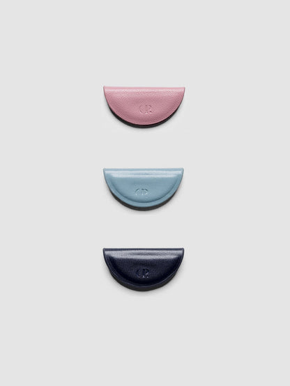 Set of three mini magnetic bookmarks in light pink, light blue, and navy blue folded in half