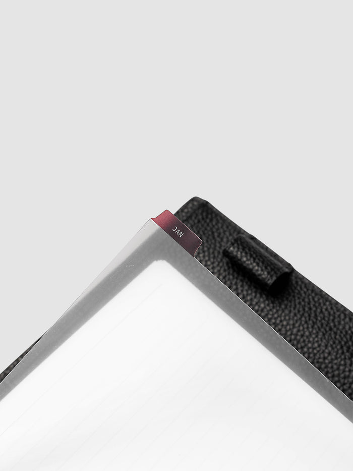 A5 6-Ring Punch Ultra-Thin Monthly Dividers in deep red shown tabbed inside a planner