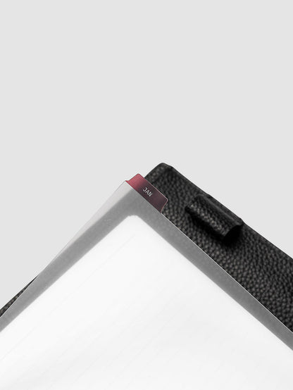 A5 6-Ring Punch Ultra-Thin Monthly Dividers in deep red shown tabbed inside a planner
