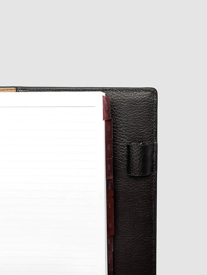 Top right corner close-up of deep red monthly divider in A5 6-Ring Punch planner showing tab label detail