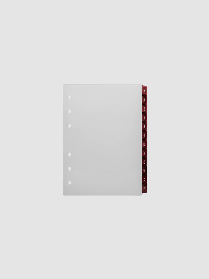 A6 6-Ring Punch Ultra-Thin Monthly Dividers in deep red, set of 12 dividers fanned to show all months