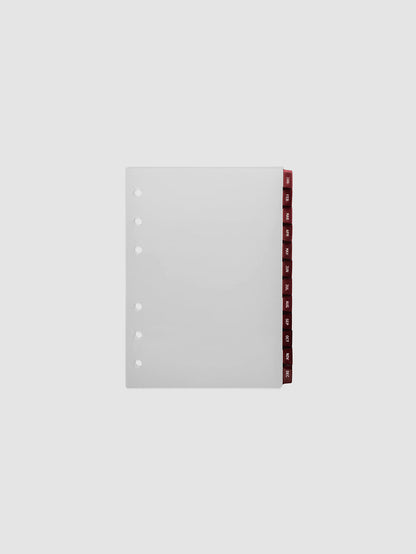 A6 6-Ring Punch Ultra-Thin Monthly Dividers in deep red, set of 12 dividers fanned to show all months