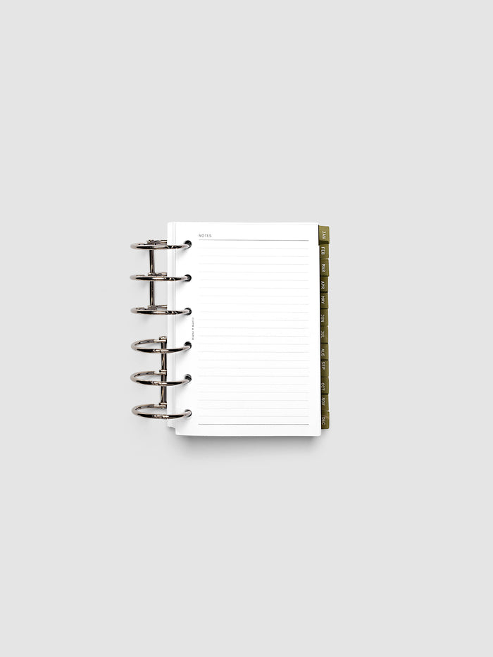 Pocket 6-Ring Punch Ultra-Thin Monthly Dividers in olive green shown tabbed inside a planner