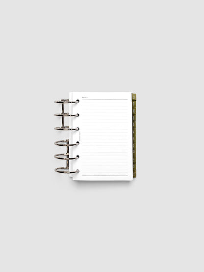 Pocket 6-Ring Punch Ultra-Thin Monthly Dividers in olive green shown tabbed inside a planner