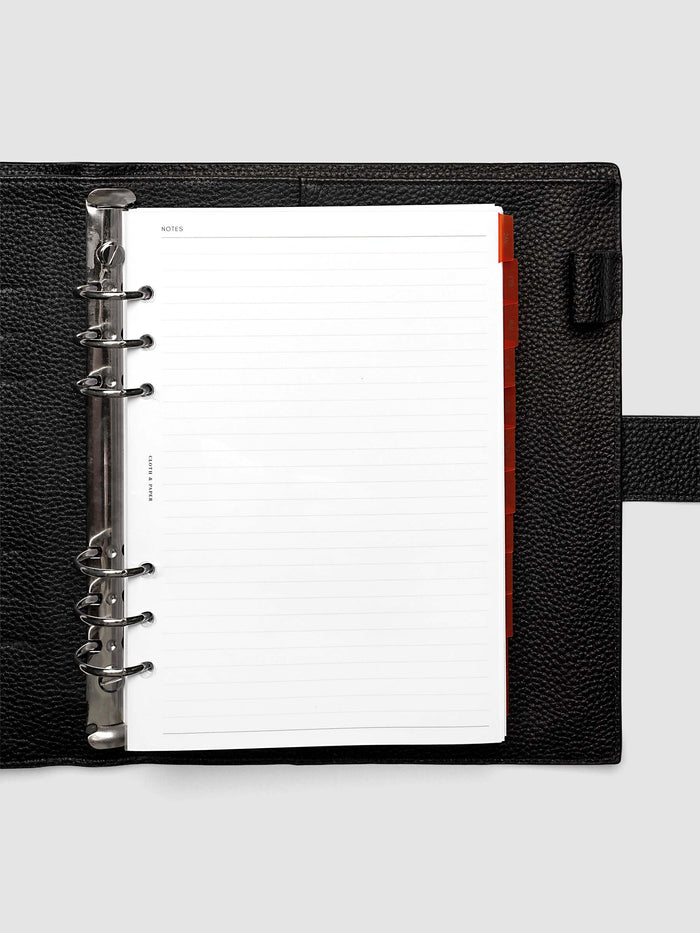 A5 6-Ring Punch Ultra-Thin Monthly Dividers in deep orange shown tabbed inside a planner