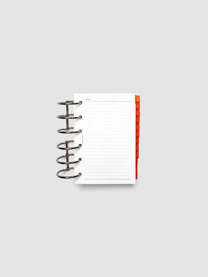 Pocket 6-Ring Punch Ultra-Thin Monthly Dividers in deep orange shown tabbed inside a planner