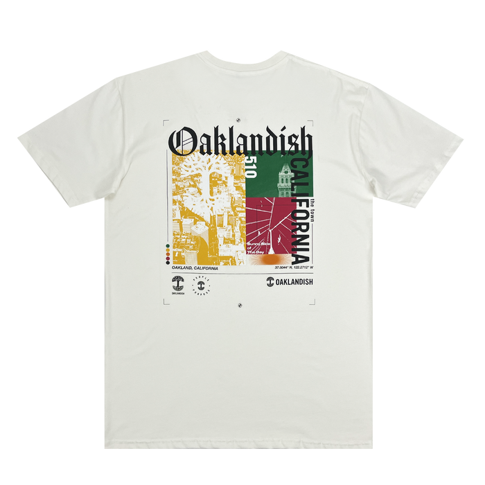 Backside view of a natural cotton-colored t-shirt with an abstract yellow, green, and red motif graphic with Oaklandish California wordmarks and logos.