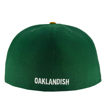 A New Era Oakland Ballers 59Fifty Cap featuring "OAKLANDISH" embroidered in white capital letters on the back. The smooth, unadorned green cap includes a partially visible button on top, making it an ideal accessory for any Oakland sports team fan.