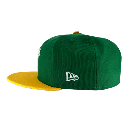 Introducing the New Era Oakland Ballers 59Fifty Cap: a stylish green baseball cap featuring a yellow brim and a small yellow button on top. The cap showcases intricate white stitching, including the iconic New Era logo on the side, making it an ideal accessory for any dedicated Oakland Ballers fan.