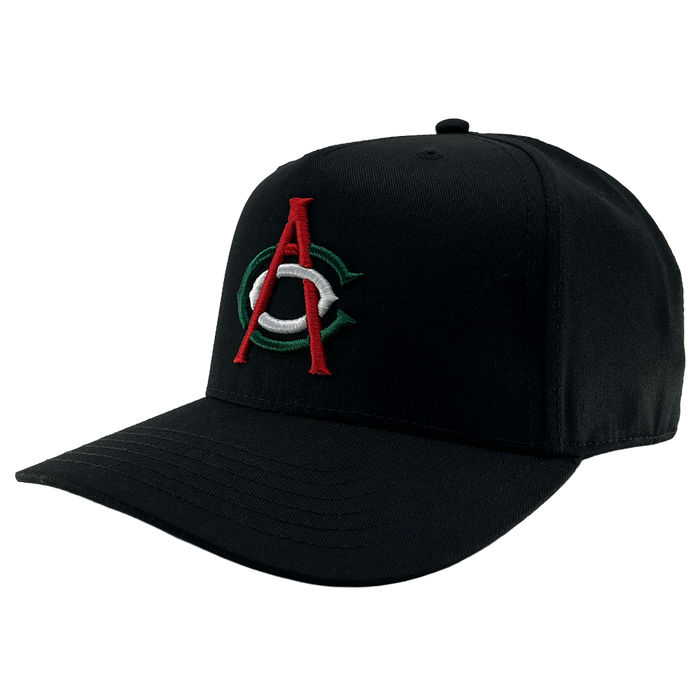 The OAC Logo 5 Panel by OAC is a black snapback cap with a structured crown and curved brim, featuring an embroidered front logo of a bold red “A” layered over a green and white “C,” representing the Oakland Athletic Club. The cap is photographed against a plain white background.