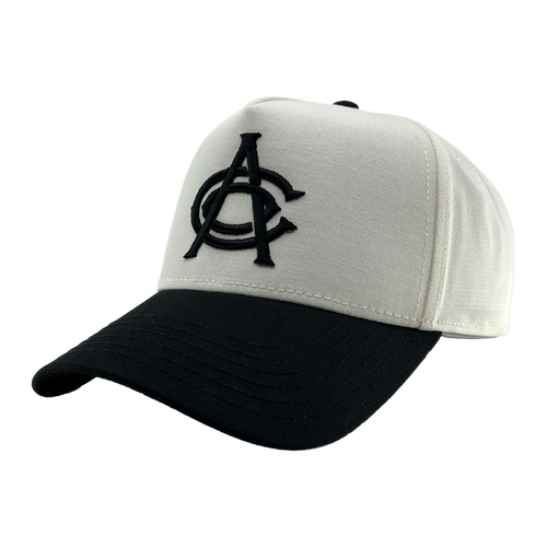 A white and black OAC Logo 5 Panel snapback cap with a curved black brim. The structured front showcases large, overlapping black embroidered “OAC” letters in a bold font—clearly representing the OAC brand. The cap is displayed against a plain, light gray background.