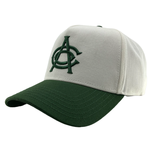 The OAC Logo 5 Panel by OAC is a white snapback cap with a dark green brim, featuring an embroidered green interlocked “A” and “C” logo on the front for the Oakland Athletic Club. Visible stitching accents the bill and crown, and it’s shown against a plain white background.