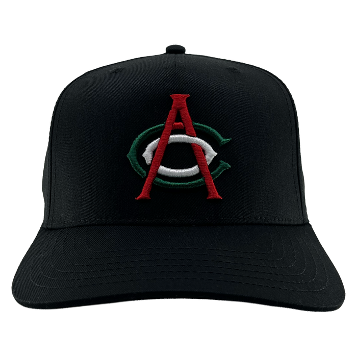 The OAC Logo 5 Panel by OAC is a black snapback cap with a curved brim, featuring an embroidered green and white “C” overlaid by a red “A” on the front to represent the Oakland Athletic Club. The cap is photographed facing forward against a plain white background.