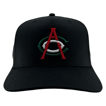 The OAC Logo 5 Panel by OAC is a black snapback cap with a curved brim, featuring an embroidered green and white “C” overlaid by a red “A” on the front to represent the Oakland Athletic Club. The cap is photographed facing forward against a plain white background.