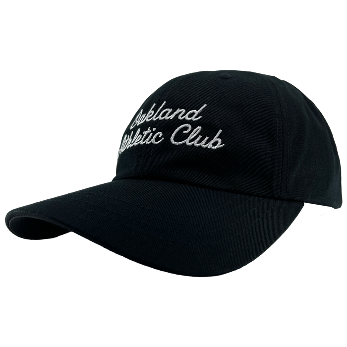 The OAC Script Dad Hat by OAC is a black dad hat with a curved brim, featuring “Oakland Athletic Club” embroidered in white cursive across the front. Designed for a customizable fit with its adjustable strap, the cap is photographed on a plain white background and angled to highlight both the brim and the detailed embroidery.