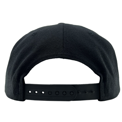 The OAC Script Snapback by OAC is displayed from the back, highlighting its plastic adjustable snapback closure with multiple holes and pegs for a customizable fit. The cap’s textured fabric adds a subtle touch of detail, making it a stylish choice—especially for fans of the Oakland Athletic Club. It rests against a plain light background.