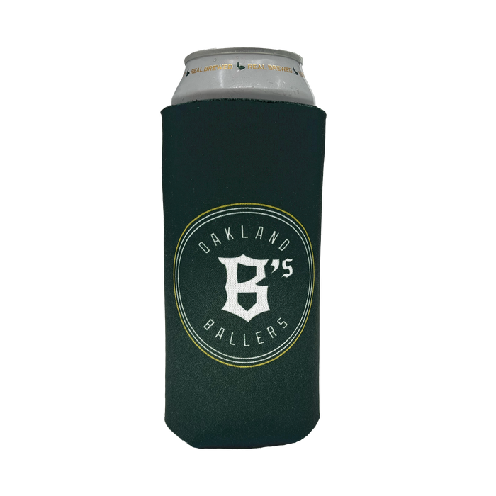A silver can is wrapped in an Oakland Ballers 24oz Can Cooler. The dark green cooler features the logo and text "OAKLAND BALLERS," celebrating Oakland's New Pro Baseball Team in the Pioneer League, with a prominent letter "B" and the number "6" combined in the center. The cooler is designed to keep beverages cool.