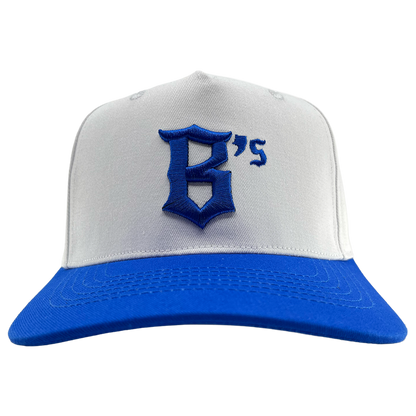The Oakland Ballers 5 Panel Cap by Oakland Ballers is a white snapback featuring a vibrant blue brim. Centered on the front, it showcases a large, stylized blue “G” followed by a small blue apostrophe and the number “5” embroidered in classic Oakland Ballers style. The background is plain white.