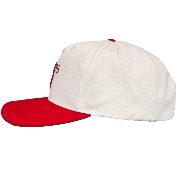 The Oakland Ballers 5 Panel Cap by Oakland Ballers is a white snapback hat with a flat red brim and button, side view. It has white panels, vent holes, visible stitching, and partial red embroidered "Oakland Ballers" text on the front. Plain white background.