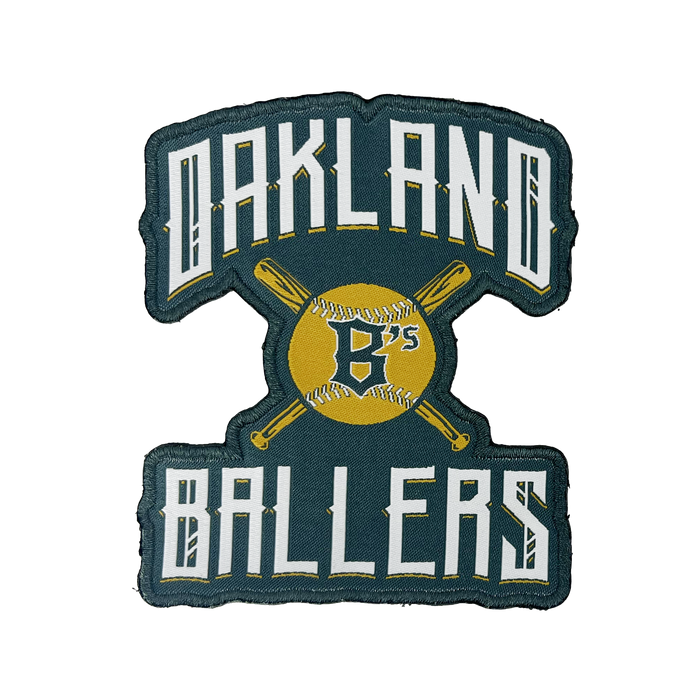 The Oakland Ballers Alt Logo Patch by Oakland Ballers features "OAKLAND BALLERS" embroidered in white with a black outline, surrounding a yellow baseball illustration crossed by two yellow bats. The baseball displays the letter "B's" in black, symbolizing the West Coast franchise, all set against a dark green background.
