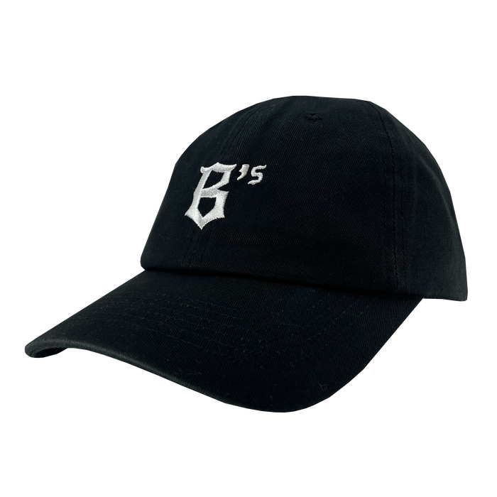 The Oakland Ballers Dad Hat is a black baseball cap with a curved brim. On the front, it showcases a white embroidered design featuring a stylized letter "B" and the number "15" slightly above and to the right, symbolizing the Oakland Ballers. Its simple and clean design makes it perfect for fans of this community-focused experience.