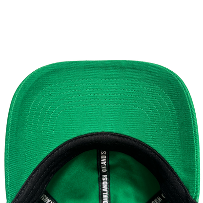 Close-up of the underside of the Oakland Ballers Dad Hat brim, highlighting detailed stitching. The black inner band displays white repeating text: "Oakland Ballers," echoing the brand's iconic style. Set against a plain white background.