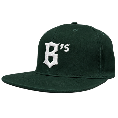 The Oakland Ballers Logo Hat by Oakland Ballers is a dark green snapback with a flat brim, featuring a white embroidered "B’s" logo on the front, inspired by the Pioneer League baseball team. Eyelets on top provide ventilation.
