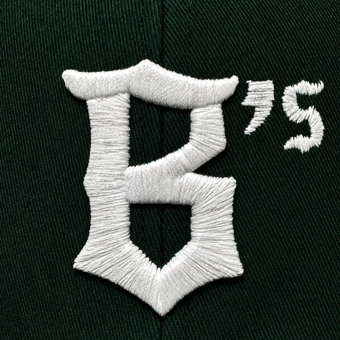 Close-up of the Oakland Ballers Logo Hat by Oakland Ballers, featuring dark green fabric with white embroidered "B’s" logo. Detailed stitching highlights this cap representing the new Oakland baseball team in the Pioneer League.