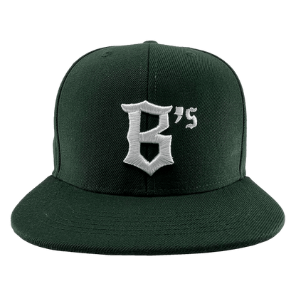An Oakland Ballers Snapback in dark green with a flat-brim design, featuring a white embroidered logo that showcases a stylized "B" followed by an apostrophe and the number 5, forming "B's". Perfect for showing support for your favorite professional baseball team, the Oakland Ballers. The cap is displayed against a white background.