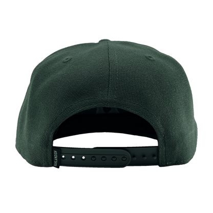 The Oakland Ballers Snapback is displayed from the back, showcasing its dark green color and snapback closure with multiple adjustment holes. The fabric looks durable, possibly made of either cotton or a blend. Small stitched vents on the sides provide ventilation.