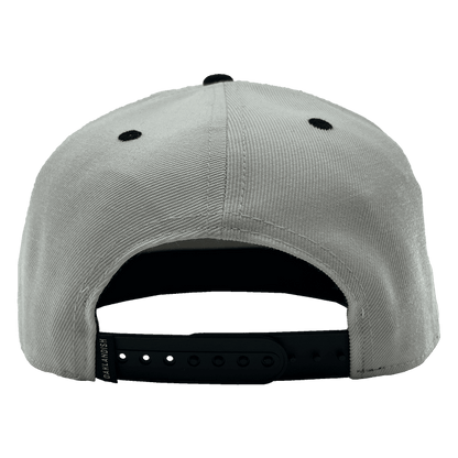 The Oakland Roots SC Arched Text Snapback is displayed from the back, highlighting black ventilation eyelets and a black adjustable snapback closure. The closure includes a branded tag with "DriLaunch" inscribed on it. Made from soft, slightly textured fabric, this light gray cap is ideal for any Oakland Roots supporter.