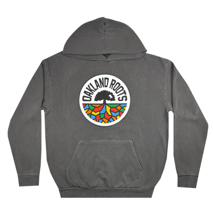 The Oakland Roots SC Heavy Hoodie by Oakland Roots SC features a front pocket and prominently showcases the "OAKLAND ROOTS" logo. The sports club's emblem includes a black tree with roots over a semi-circle in vibrant blue, orange, green, and yellow shades, with the text elegantly arching above the tree.