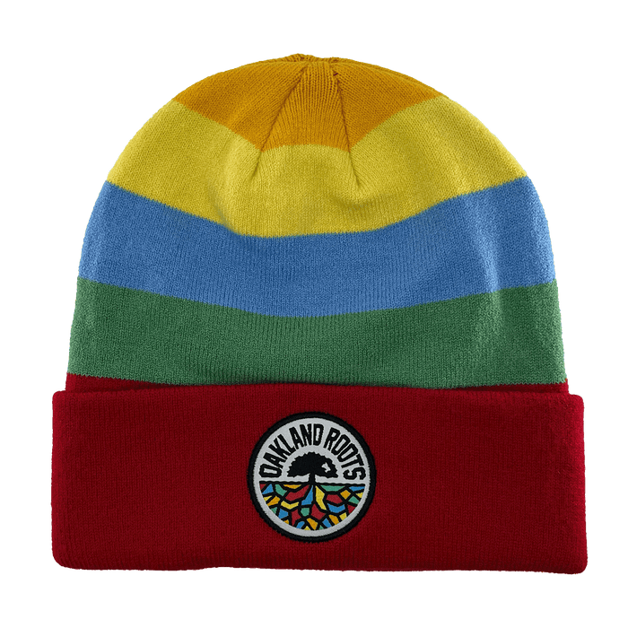 The Oakland Roots SC Mosaic Stripe Beanie features horizontal stripes in yellow, blue, and green, along with a red fold-over cuff. The cuff proudly displays a circular patch with the text "OAKLAND ROOTS," a black tree logo, and rainbow-colored roots to show your support for the Oakland Roots Sports Club.