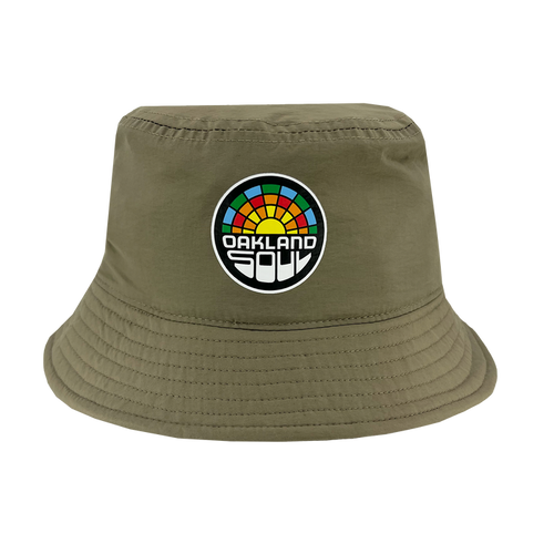 The Oakland Soul Logo Bucket Hat by Oakland Soul showcases an olive green design with a vibrant, circular rainbow logo on the front. The mosaic-like logo includes segments in red, orange, yellow, green, and blue and features "OAKLAND SOUL" in white, celebrating the women's soccer team that promotes social good. The hat is finished with a downward-sloping brim and detailed stitching for added style.