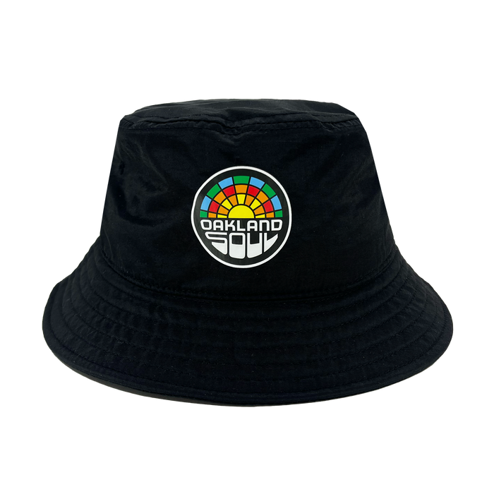 Check out the Oakland Soul Logo Bucket Hat, a stylish black bucket hat adorned with the Oakland Soul logo on the front. The vibrant, multi-colored semicircle evokes a rainbow, with "OAKLAND" displayed prominently in bold white letters and "SOUL" in smaller white letters beneath it. Show your support for this inspiring women's soccer team in the USL W-League!