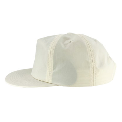A side view of the Oakland Soul Surf Cap, featuring a plain beige design. The cap has a flat brim, six panels with matching beige stitching, and two ventilation holes on the topmost panel. The Oakland Soul USL W-League women's soccer team logo is subtly embroidered on the front. It is displayed against a white background.