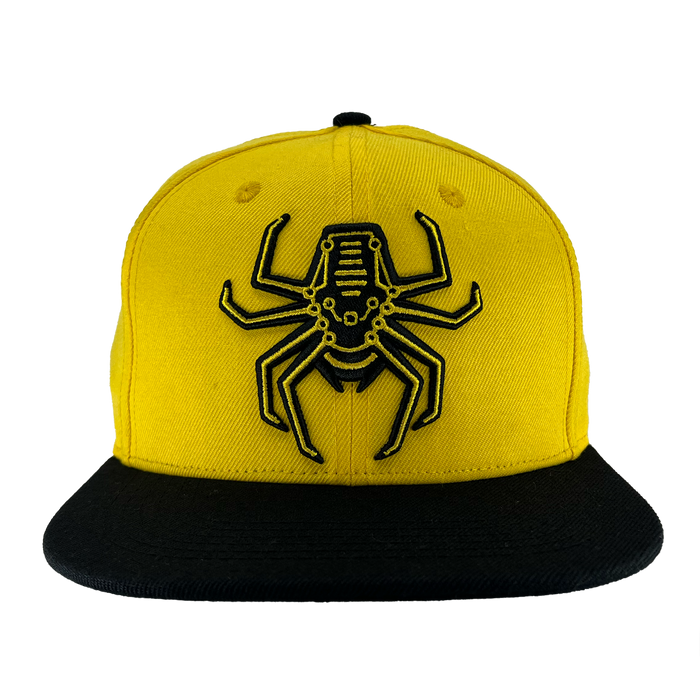 Front view of yellow snapback hat with Oakland Spiders logo on crown and black brim.