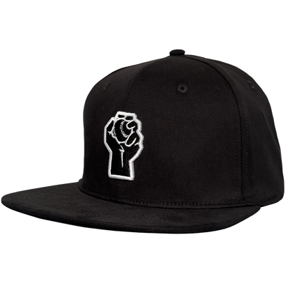 The Oakland Stand Up Hat by Oakland Ballers is a black snapback with a flat brim, featuring an embroidered white outline of a raised fist holding a baseball on the front panel—an homage to the team.