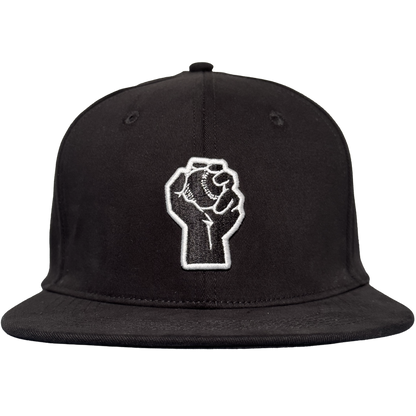 The Oakland Stand Up Hat by Oakland Ballers is a black flat-bill cap with an embroidered white raised fist on the front, symbolizing solidarity and resistance—a bold tribute to the team from the Pioneer League.