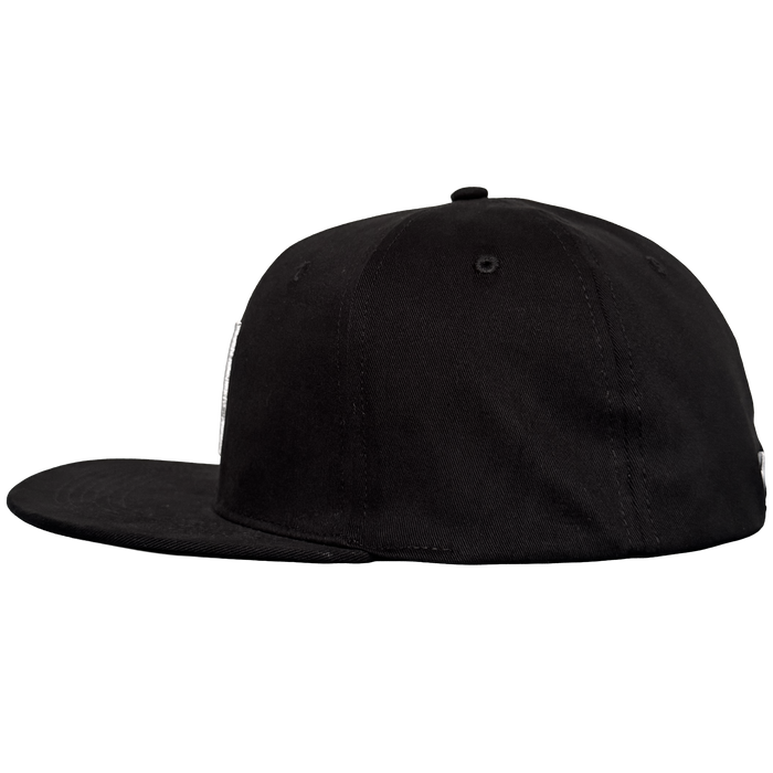 The Oakland Stand Up Hat by Oakland Ballers is a black, flat-brim baseball cap with a structured crown and small top button, shown from the left side on a plain light gray background. The cap has no visible logos or designs.
