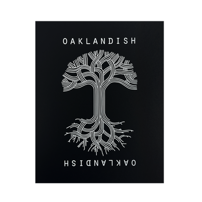 A symmetrical tree with branched lines forming roots and branches is centered against a black background in the Oaklandish Classic Logo Print by Never Elsewhere. The white text "OAKLANDISH" appears above and below the tree, with the lower text inverted. The design has a modern, graphical look reminiscent of a letterpress print, creating a striking contrast.