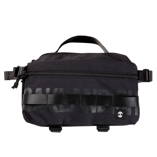 A black nylon hip bag with a black Oaklandish wordmark, front zipper, top handle, waist belt, & small white Oaklandish tree logo.