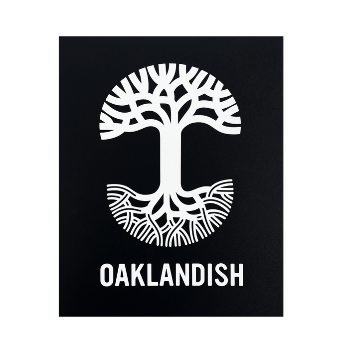 A black background showcases a striking white graphic of a tree creatively designed to resemble the letter "T," with the top half depicting branches and the bottom half depicting roots. Below this symbolic tree, "OAKLANDISH" is prominently featured in uppercase letters on a silver foil cardstock print, known as the Oaklandish New Logo Print by Never Elsewhere.