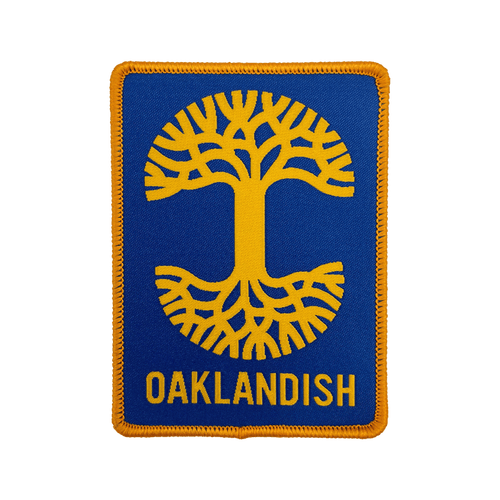 Royal blue woven iron-on patch with gold Oaklandish tree logo and wordmark.